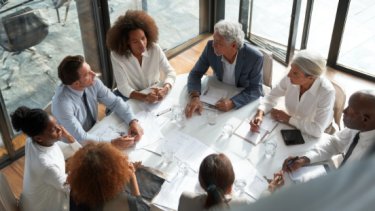 IAE25 press release image of a business meeting