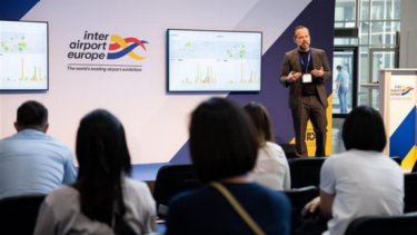 IAE image of a speaker in front of the audience