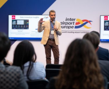 A speaker in front of attendees