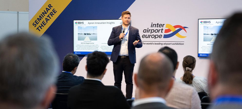 A speaker presenting at a seminar at inter airport Europe